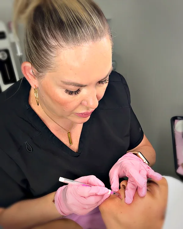 Antonina, PMU artist and lash lift specialist, performing lip blush at Glow Up Suite